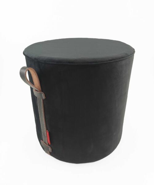 Handcrafted pouf styled in an open desert space with minimal decor