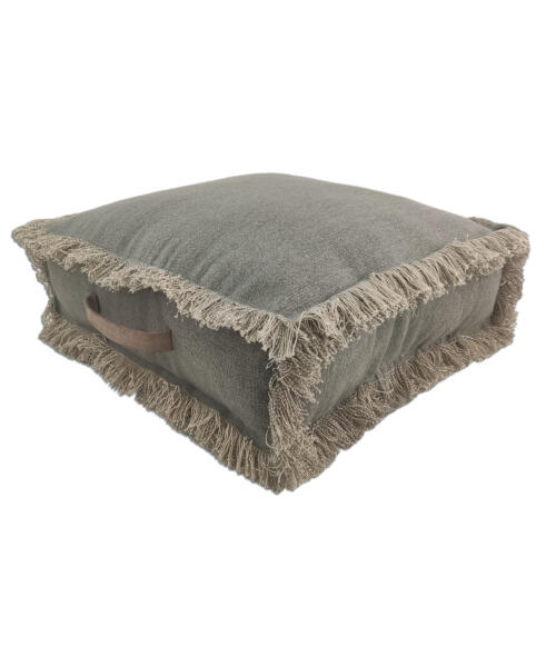 Modern pouf used as a footrest next to a cozy armchair