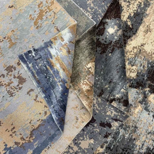 Hand knotted rugs half folded on top of each other showcasing texture and weave