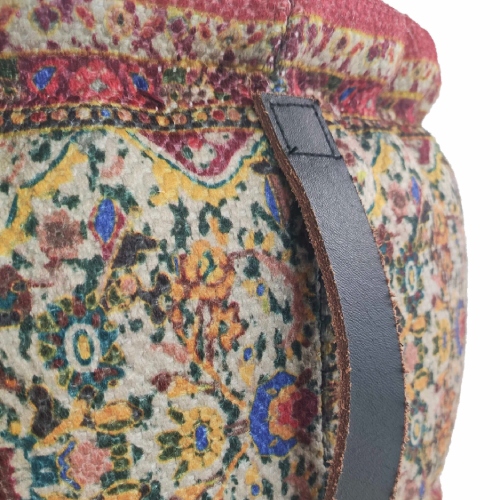 Close-up of leather handle on multi-color braided pouf with polyester and jute-thermocol filling