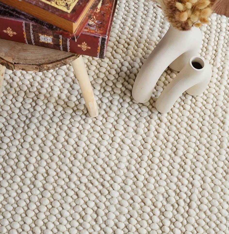 Close-up of woven rug with decorative items placed on top